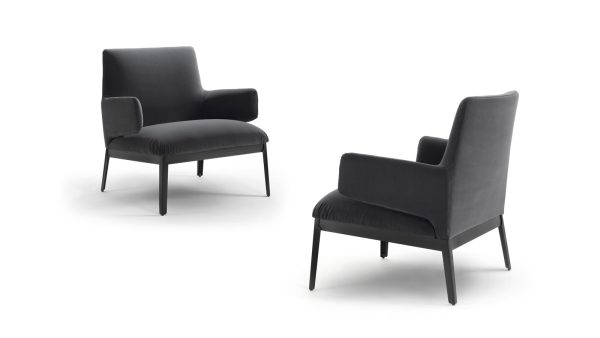 The Hug Armchair - Low version by Claesson Koivisto Rune for Arflex is an elegant and inviting piece of designer furniture that exudes luxury and sophistication. Its unique "open-armed" armrests are designed to resemble a welcoming hug, inviting you to sit and relax in comfort. Side and Back View