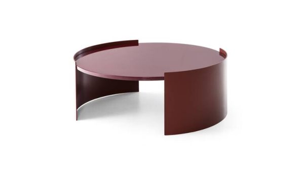 The Bowy coffee tables by Patricia Urquila for Cassina have a sleek, round design with simple minimalist lines. They come in two different finishes: a glossy lacquered finish reminiscent of the 1970s or a more rustic, textured wooden top.