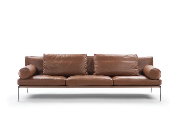 The innovative and delightful Happy Sofa designed by Antonio Citterio for Flexform. Elegant metal legs support the plump cushions and beguiling bolster. The sofa here is shown in a tan leather - Front View