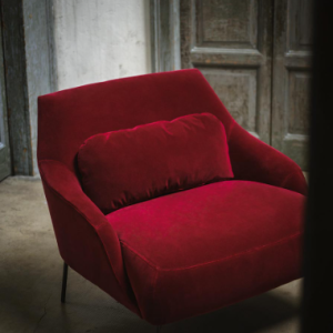 The sensual and sensational Lima armchair by Swedish designers, Claesson Koivisto Rune, weds ergonomic pleasure with a deep, inviting, and outlandishly comfortable seat thanks to the additional back cushion. Shown here in a deep red velvet fabric.